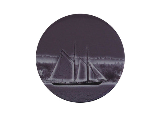 Bluenose II, the internationally renowned schooner, designed and constructed in Lunenburg, Nova Scotia, gliding along the tranquil waves of Blue Rocks Harbour. It is a perfect piece of art to add to any room. This beautiful round wood panel features unique Bluenose monochrome photography coated with resin, measuring 8 inches in diameter. Ready to hang on the wall, this piece will add a touch of originality to your home.