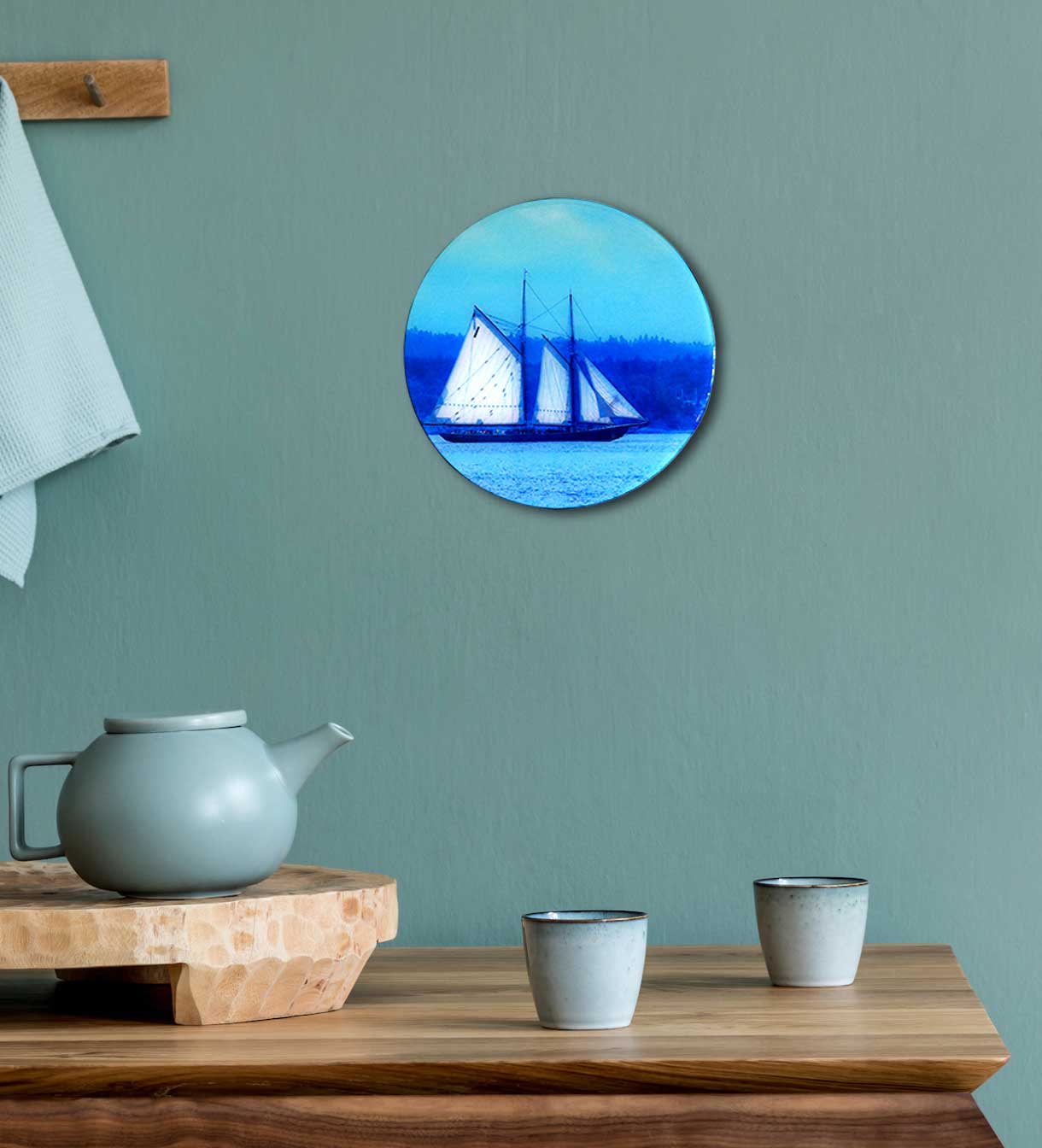 Bluenose II, the internationally renowned schooner, designed and constructed in Lunenburg, Nova Scotia, gliding along the tranquil waves of Blue Rocks Harbour. It is a perfect piece of art to add to any room. This beautiful round wood panel features unique Bluenose photography coated with resin, measuring 8 inches in diameter. Ready to hang on the wall, this piece will add a touch of originality to your home.