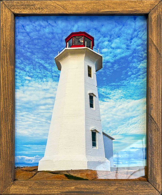 The Peggys Cove Lighthouse is an iconic symbol of Nova Scotia. The photography measures 9.25 x 7.5 inches is resin-coated and presented in a tasteful handmade wooden frame 10.75 x 9 inches. ready-to-hang on your wall.