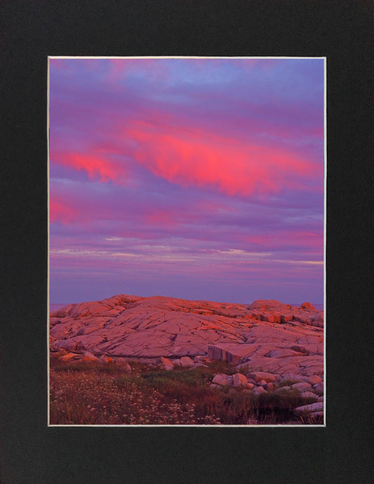 Granite boulders at Peggys Cove with a rose-tinted sky at the end of the day Print on hight quality paper 9.5 x 7.5 inches with a black mat 12 x 10.5 inches.  Place the photography in a frame of your choice and hang it in your favorite decor.
