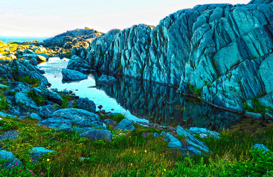 Reflections of the picturesque rock formations at Cape Forchu, near Yarmouth, Nova Scotia. The water and rocks found throughout the region make for very colorful reflections. Resin-coated 11 x 17 inches photo. Now it's up to you to find the perfect wall that will bring out the vibrant colors.