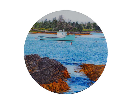 this traditional fisherman's boat with its turquoise hull floats on the undulating tide of the Atlantic Ocean off Blue Rocks. This beautiful round wood panel features photography coated with resin, measuring 8 inches in diameter.  Ready to hang on the wall, this work will add a touch of originality to your interior.