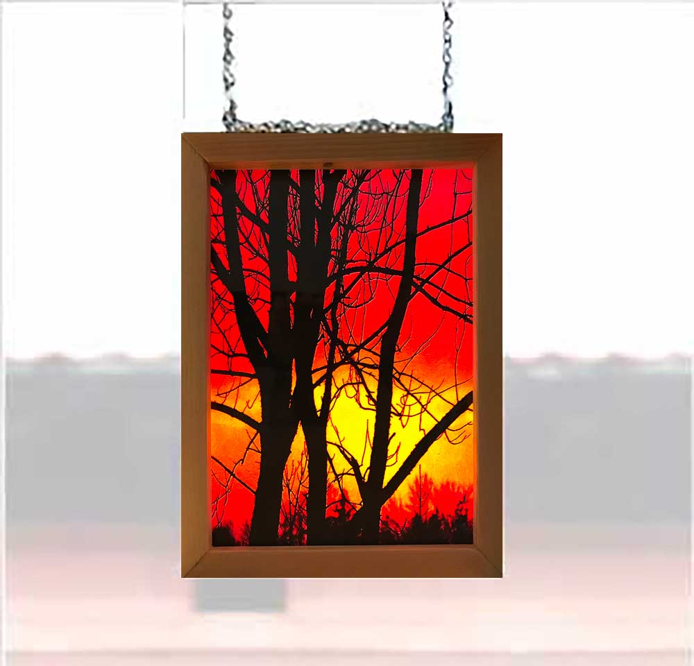 This 9 x 6.75 inches photography of Pictou sunset has been printed on two vellum papers to create a stained glass effect.   Two pieces of glass were cut and placed in a handmade wooden frame 10.25 x 8.25 inches.   Hooks and chains were added to allow them to be hung in a window, allowing light to pass through the frame. Y
