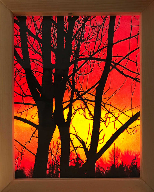 This 9 x 6.75 inches photography of Pictou sunset has been printed on two vellum papers to create a stained glass effect. Two pieces of glass were cut and placed in a handmade wooden frame 10.25 x 8.25 inches. Hooks and chains were added to allow them to be hung in a window, allowing light to pass through the frame. 